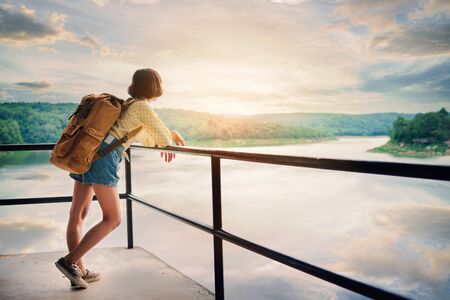Asian girl backpack on the park background, journey and traveling on holiday concept.の写真素材