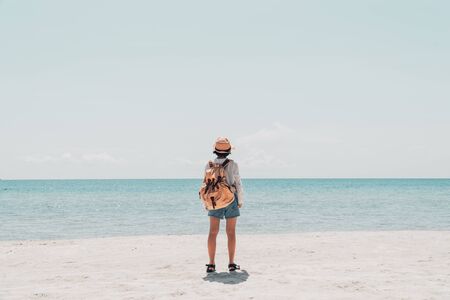 Cute girl backpack and travel on the beach.の写真素材