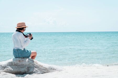 The tourist shooting in the sea on a beautiful day.の写真素材