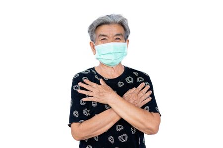 Old woman wearing a mask fear problem covid 19 and air pollution on a white background,stay at home ,healthcare concept,new normal.の写真素材