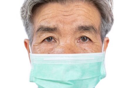 Old woman wearing a mask fear problem covid 19 and air pollution on a white background,stay at home ,healthcare concept,new normal.の写真素材