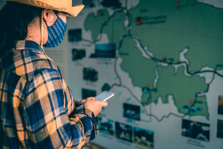 Young woman using smartphone searching for attractions on holiday.の写真素材