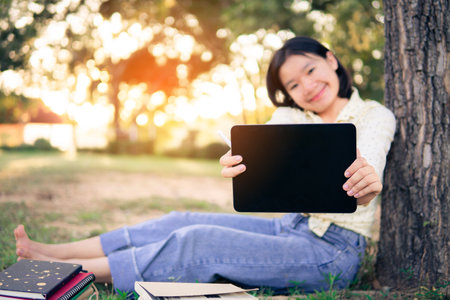 Asian female high school happy using tablet e leaning online class. selective and soft focus.の写真素材