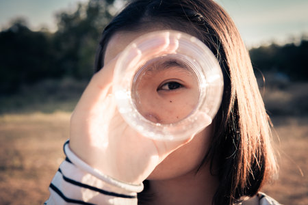 A girl holding plastic bottle, save the world from plastic conceptの写真素材
