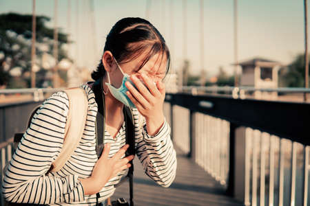 The new normal a girl wearing a mask during travel and public place.