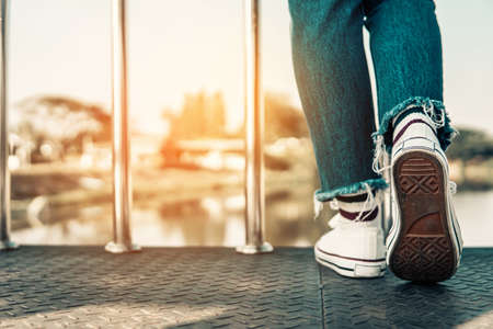 hipster tourist traveler feet on bridge background, resting lifestyle on vacation.の写真素材