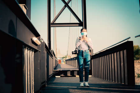 The new normal a girl wearing a mask during travel and public place.