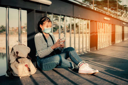The new normal asian girl using smartphone searching the location to travel during the pandemic...