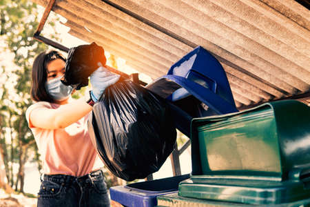 Volunteer holding plastic garbage Clean to dispose of waste properly.の写真素材