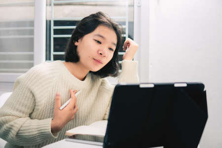 Home school Asian student learning online from lockdown epidemic.の写真素材