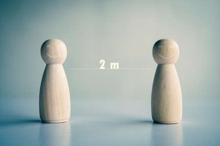 Wooden doll on the table to social distance 2 meters in crisis .の写真素材