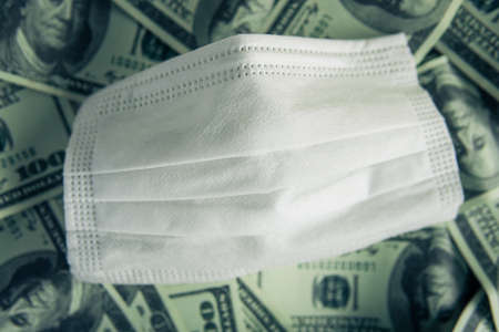 Top view white mask on the banknote background.の写真素材