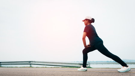 Women warm up before running on the road, sets new goal to start running exercise, selective and soft focus.の写真素材