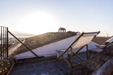 Hammock on terrace facing sunset in Cagliari, Italy  の写真素材