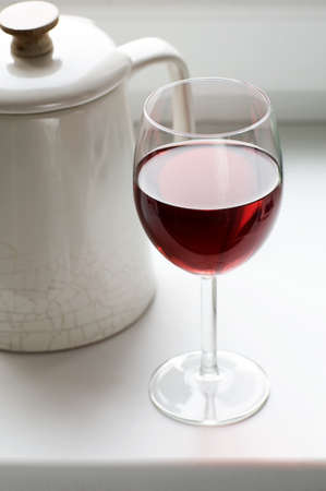 Glass of wine and old kettlerの写真素材