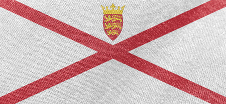 National fabric flag of the state of Jersey. Fabric textured background of Jersey flag cotton materialの写真素材