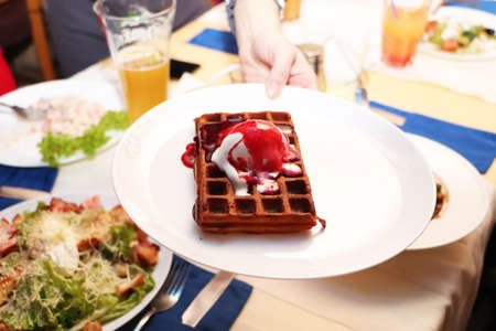 Belgian waffle on a table in a cafeの写真素材