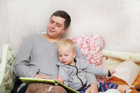 Dad reads his son a bedtime storyの写真素材