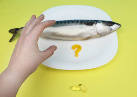 Oily fish mackerel and (or) food supplement omega-3 in capsules. Concept of choice