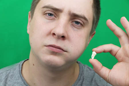 A man after removing a wisdom tooth. The operation to remove the eighth teethの写真素材