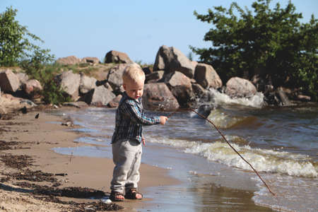 Little boy playing on the beachの写真素材
