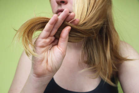 Damaged Hair. Beautiful Sad Young Woman With Long Disheveled Hair. Hair Damage, Health And Beauty Conceptの写真素材