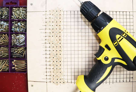 The man works as a drill in the workshop