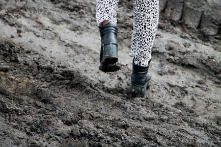 Shoes in the mud. Photo in motion. The concept of provincialismの写真素材