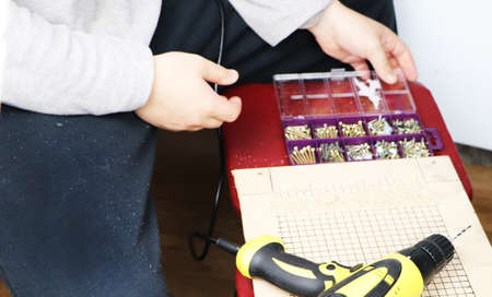 The man works as a drill in the workshop