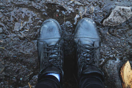 Black shoes in the mud. View from aboveの写真素材