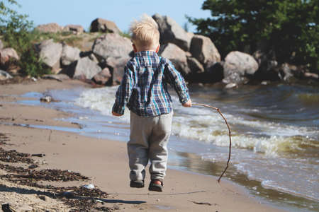 Little boy playing on the beachの写真素材