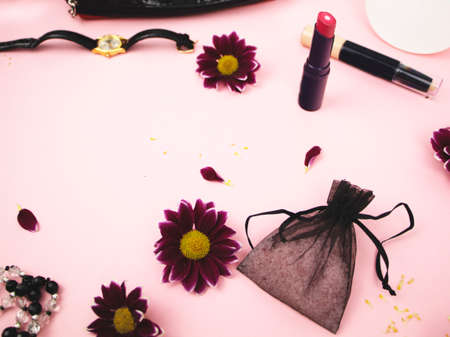 Cosmetics on the table at the woman. Cosmetic bag, cosmetic and hygiene products. Pink background for textの写真素材