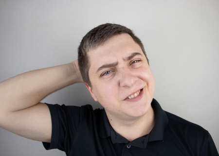 A man suffers from pain in the back of his head. Signs of cervical osteochondrosis, spondylosis,...