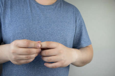 A man grows fingers that hurt and pull. Arthritis or arthrosis of the joints and its treatment. Finger pain conceptの写真素材