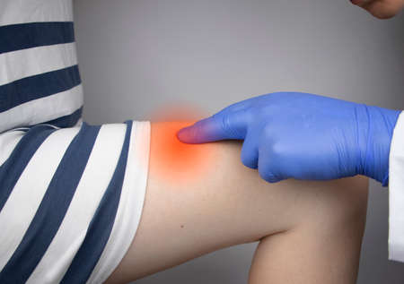 The vascular surgeon examines the outer thigh where the varicose veins are present. Preparation for...