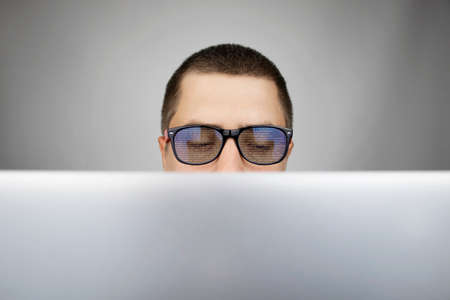 The programmer's glasses reflect lines of code. Programming, development of applications, sites and other things. Software development conceptの写真素材