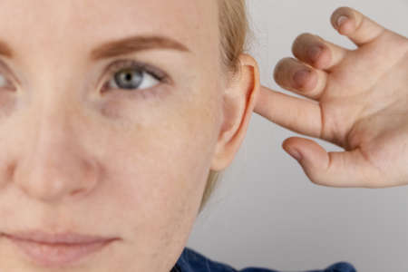 Darwin's tubercle on the ear. The girl at the reception at the plastic surgeon, shows the auricle.
