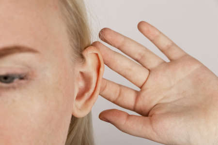 Darwin's tubercle on the ear. The girl at the reception at the plastic surgeon, shows the auricle.の写真素材