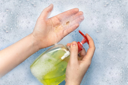 Bottles of detergents float in the foam. The concept of the dangers of household chemicals. Sodium...