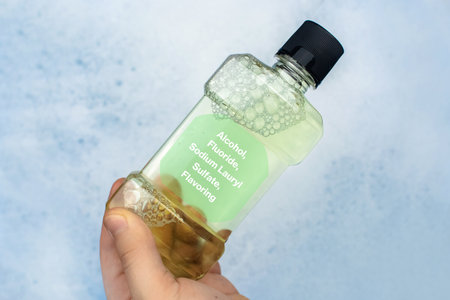Mouthwash floating in soapy water. Harmful composition of ingredients. Rinse aid with Sodium Lauryl...
