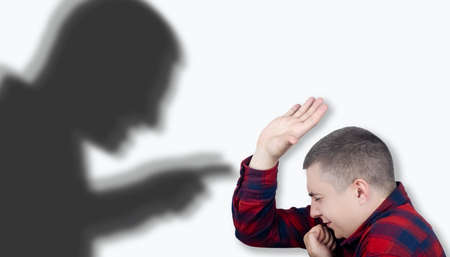 The man is experiencing a panic attack. The concept of phobia, fears, paranoia and persecution mania. Shadow silhouettes surrounded the man. Nervous breakdown and nervous disordersの写真素材