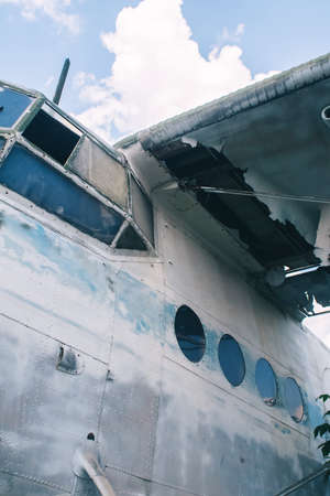 Close-up of a crashed airplane wing. The metal frame and internal parts are visible. Pieces of...