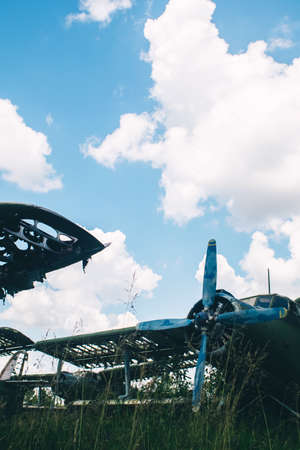 A close-up of an old aircraft engine showing rust and breakage. Visible radiator, blades, internal...