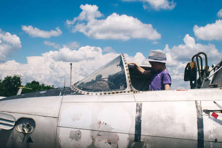 Close-up of a military fighter pilot's cockpit. A crack is visible on the glass, which has turned yellow with age. Decommissioned military equipment. Airplane pilot seatの写真素材