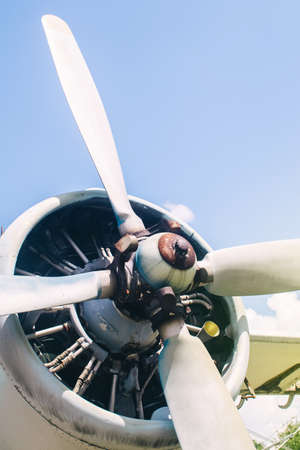 A close-up of an old aircraft engine showing rust and breakage. Visible radiator, blades, internal parts and traces of metal corrosionの写真素材
