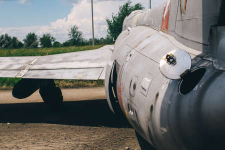 Close-up of part of the fuselage of an old military fighter jet, which has an open fuel system. The open tank of the aircraft, the metal cover is clearly visibleの素材 [FY310170450883]