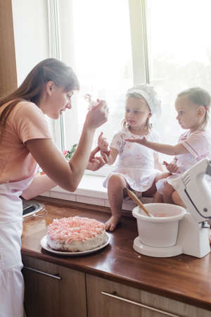 Children in the kitchen cook with their parents. Making homemade cake, pastries or cookies for the...