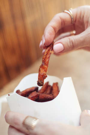 Ð¡arrot fries in a cardboard box. Vegetarian fast food dish. Grilled vegetables. BBQ cooking concept for people who do not eat meat or like vegetablesの写真素材