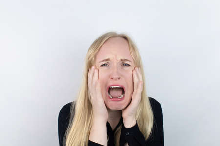 The woman is experiencing a panic attack. The concept of phobia, fears, paranoia and persecution mania. Shadow silhouettes surrounded the man. Nervous breakdown and nervous disordersの写真素材