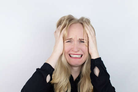 The woman is experiencing a panic attack. The concept of phobia, fears, paranoia and persecution mania. Shadow silhouettes surrounded the man. Nervous breakdown and nervous disordersの写真素材